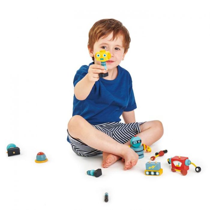 boy playing with wooden robot toy