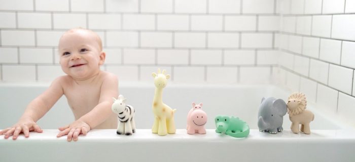 baby in bath with natural rubber bath toys